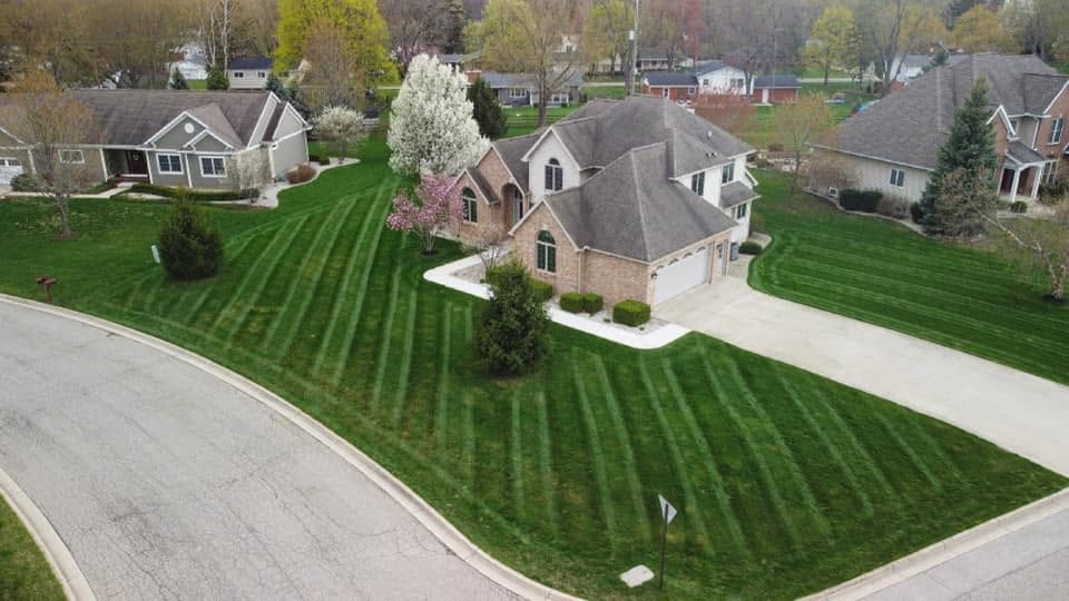 Riding lawn mower cutting grass